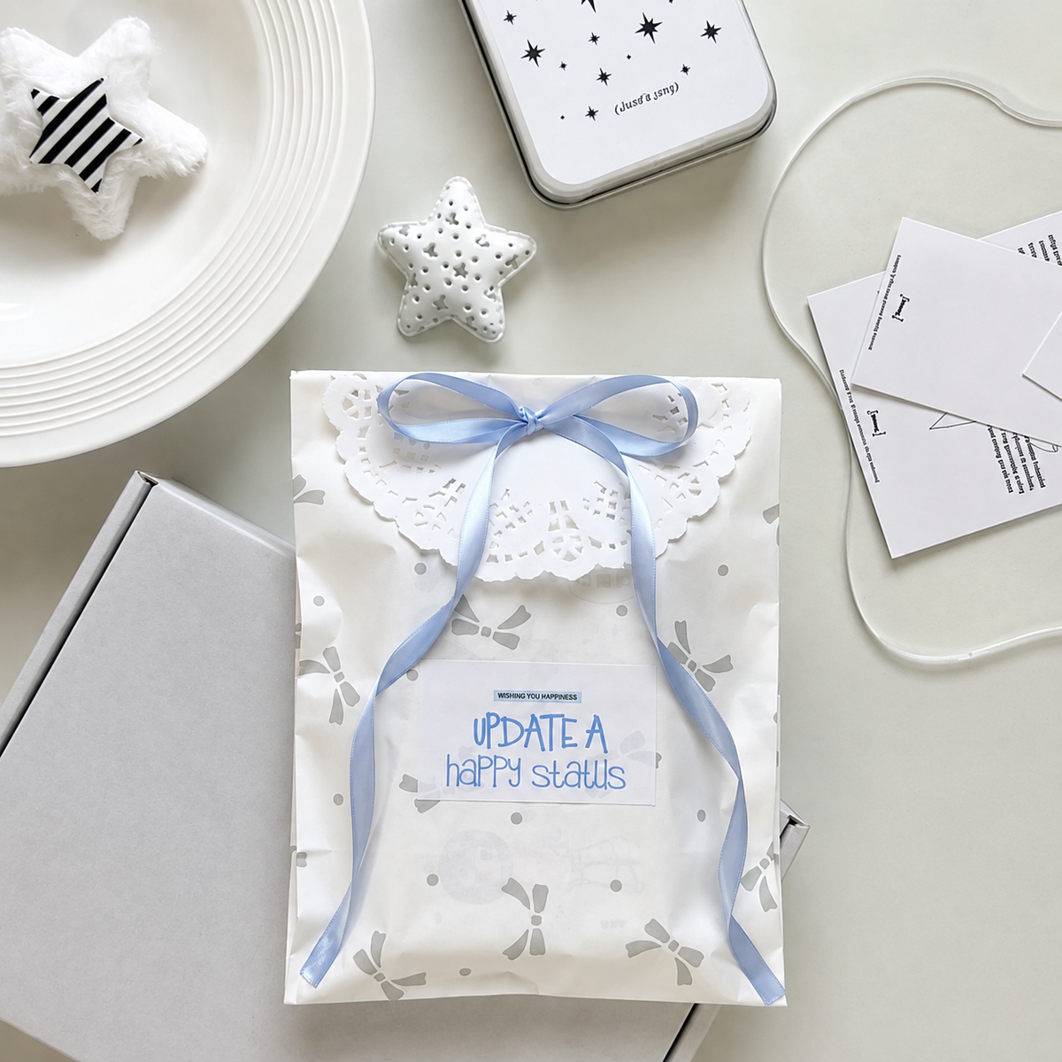 White gift box with blue ribbon and packaging accessories